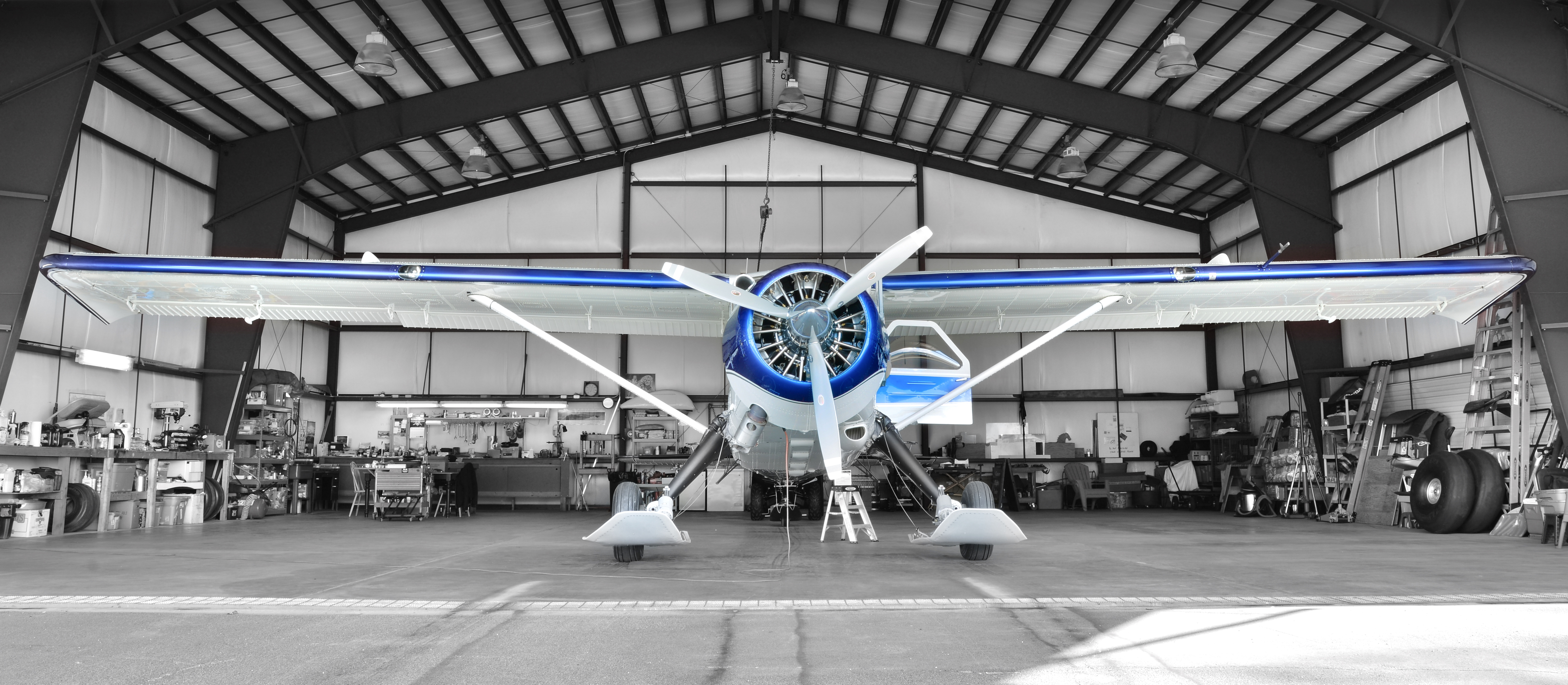 Background image displaying a plane in a hangar.